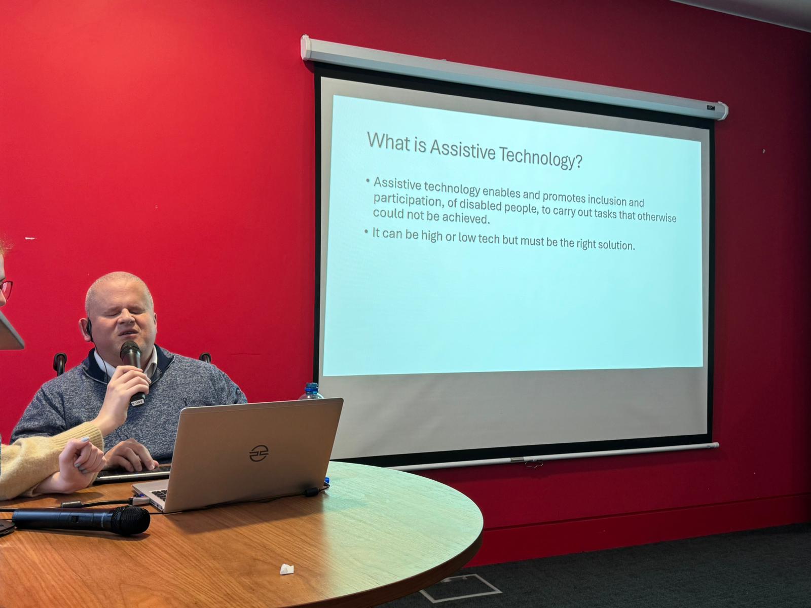 Brian sat at a desk while delivering his talk