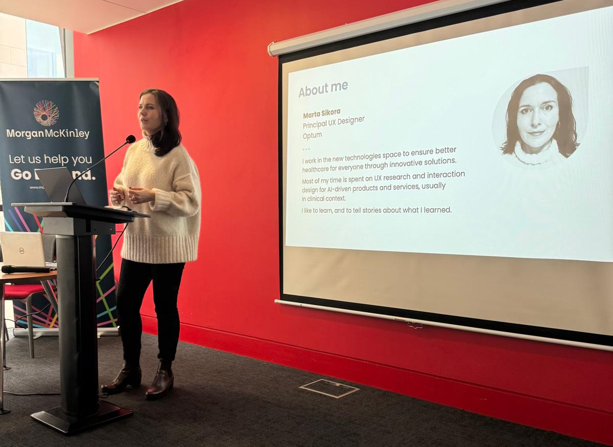 Marta standing at the podium while delivering her talk.